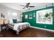 Comfortable bedroom featuring a ceiling fan, hardwood floors, and abundant natural light at 2805 Fayetteville St, Durham, NC 27707