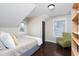 Bright bedroom offers hardwood floors, two windows, and a comfortable sitting area at 2805 Fayetteville St, Durham, NC 27707