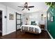 Bedroom features a sliding barn door, ceiling fan, and hardwood floors at 2805 Fayetteville St, Durham, NC 27707