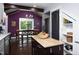 Eat in kitchen featuring a refrigerator and purple accent wall at 2805 Fayetteville St, Durham, NC 27707