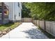 Long driveway alongside a fenced yard, offering ample parking and privacy at 2805 Fayetteville St, Durham, NC 27707