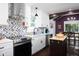 Modern kitchen with white cabinets and stainless steel appliances at 2805 Fayetteville St, Durham, NC 27707