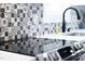 Close up on the kitchen features a stylish tile backsplash at 2805 Fayetteville St, Durham, NC 27707