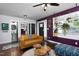 Bright living room featuring hardwood floors, a modern sofa, vibrant walls and decorative plants by a window at 2805 Fayetteville St, Durham, NC 27707