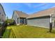 The home's backyard has a metal fence, green grass, a patio, and siding at 2837 Milano Ave, Apex, NC 27502