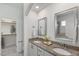 Bathroom featuring double granite sinks, two framed mirrors and a walk-in closet on the side at 2837 Milano Ave, Apex, NC 27502