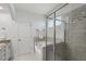 Bathroom with a corner tub, glass-enclosed shower with tiled walls, and granite countertops at 2837 Milano Ave, Apex, NC 27502