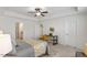 A bright bedroom featuring a ceiling fan, neutral walls, and natural light from the window at 2837 Milano Ave, Apex, NC 27502