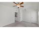 A bright empty bedroom featuring neutral walls, carpeted floors, a ceiling fan, and natural light at 2837 Milano Ave, Apex, NC 27502