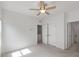 This bedroom features neutral walls, carpet flooring, a ceiling fan and a double door closet at 2837 Milano Ave, Apex, NC 27502