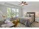 Bright bedroom with large windows, neutral décor, and a ceiling fan at 2837 Milano Ave, Apex, NC 27502