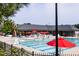 Large community pool with lifeguard, slide, umbrellas, tables, and chairs, providing a luxurious outdoor experience at 2837 Milano Ave, Apex, NC 27502