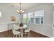 Bright dining area featuring wood floors, and a modern chandelier at 2837 Milano Ave, Apex, NC 27502