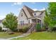 Inviting two-story home with a beautifully landscaped front yard and charming architectural details at 2837 Milano Ave, Apex, NC 27502