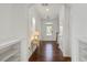 Bright foyer with hardwood floors, elegant console table, and arched entryways at 2837 Milano Ave, Apex, NC 27502