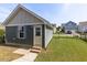 The garage is detached and surrounded by green grass, siding, and trim at 2837 Milano Ave, Apex, NC 27502