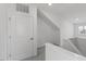 The bright hallway offers neutral paint, trim, carpet flooring, and access to upper level at 2837 Milano Ave, Apex, NC 27502