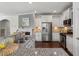 Open kitchen with granite counters, stainless appliances and breakfast bar at 2837 Milano Ave, Apex, NC 27502