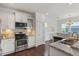 Gourmet kitchen with granite counters, backsplash and stainless appliances at 2837 Milano Ave, Apex, NC 27502