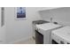 Functional laundry room with granite countertop, modern washer, and dryer at 2837 Milano Ave, Apex, NC 27502