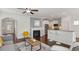 Living room with kitchen view, fireplace, and a neutral color palette at 2837 Milano Ave, Apex, NC 27502