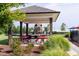 A shady picnic area offering red picnic tables and a playground, perfect for families to relax and play at 2837 Milano Ave, Apex, NC 27502