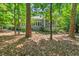 Back exterior view of gray home with screened porch and a stone landscaped yard at 289 Stoneview, Pittsboro, NC 27312