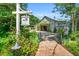 Exterior view of the Fearrington Barn surrounded by lush greenery and a brick pathway at 289 Stoneview, Pittsboro, NC 27312