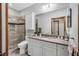 Bathroom featuring a granite countertop, white cabinets, and glass shower at 289 Stoneview, Pittsboro, NC 27312