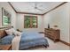 Comfortable bedroom featuring a wooden bed frame, ceiling fan, and a window with wooded outdoor views at 289 Stoneview, Pittsboro, NC 27312