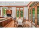 Bright dining area with wood trim, hardwood floors, and large windows overlooking the backyard at 289 Stoneview, Pittsboro, NC 27312