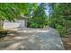 Long concrete driveway leads to a two-car garage and mature landscaping at 289 Stoneview, Pittsboro, NC 27312