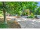 Long driveway with a circular turnaround area is surrounded by mature landscaping at 289 Stoneview, Pittsboro, NC 27312