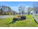 Entrance to the Fearrington Village Center with stone flower bed and white fencing at 289 Stoneview, Pittsboro, NC 27312