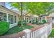 Attractive exterior with large windows, brick path, and decorative white picket fence at 289 Stoneview, Pittsboro, NC 27312