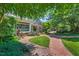 Charming bookstore exterior featuring a brick walkway, benches, and lush landscaping at 289 Stoneview, Pittsboro, NC 27312