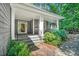 Inviting front porch with stone steps and elegant columns on a gray shingle home at 289 Stoneview, Pittsboro, NC 27312