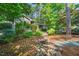 Landscaped front yard with stone pathway leading to a charming home with lush greenery at 289 Stoneview, Pittsboro, NC 27312