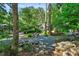 Charming home nestled among lush trees and natural rock landscaping at 289 Stoneview, Pittsboro, NC 27312