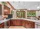 Gourmet kitchen with wood cabinets, granite countertops, stainless appliances, and a view of the backyard at 289 Stoneview, Pittsboro, NC 27312