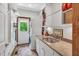 Bright laundry room featuring a stacked washer and dryer, sink, and storage at 289 Stoneview, Pittsboro, NC 27312