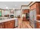 Spacious living room and kitchen featuring a fireplace, hardwood floors, and stainless steel appliances at 289 Stoneview, Pittsboro, NC 27312