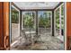 Cozy screened porch with stone flooring, a ceiling fan, and serene wooded views at 289 Stoneview, Pittsboro, NC 27312