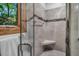 Beautiful shower with tile surround, glass door, and window views at 289 Stoneview, Pittsboro, NC 27312