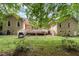 Backyard featuring a deck, grill, and a lawn with mature trees offering privacy at 3 Bent Oak Ct, Durham, NC 27705