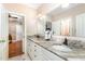 Bathroom with marble countertops, white cabinets, and double sink at 3 Bent Oak Ct, Durham, NC 27705