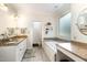 Bathroom featuring dual granite-topped vanities, a makeup counter, and a large tub with mosaic tile accents at 3 Bent Oak Ct, Durham, NC 27705
