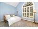 Bedroom with large window and neutral colors at 3 Bent Oak Ct, Durham, NC 27705