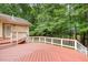 Red-stained wooden deck featuring white railings offering an outdoor living and entertaining space at 3 Bent Oak Ct, Durham, NC 27705