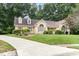 Attractive single-story brick house with manicured lawn, dormer windows, and mature trees providing privacy at 3 Bent Oak Ct, Durham, NC 27705